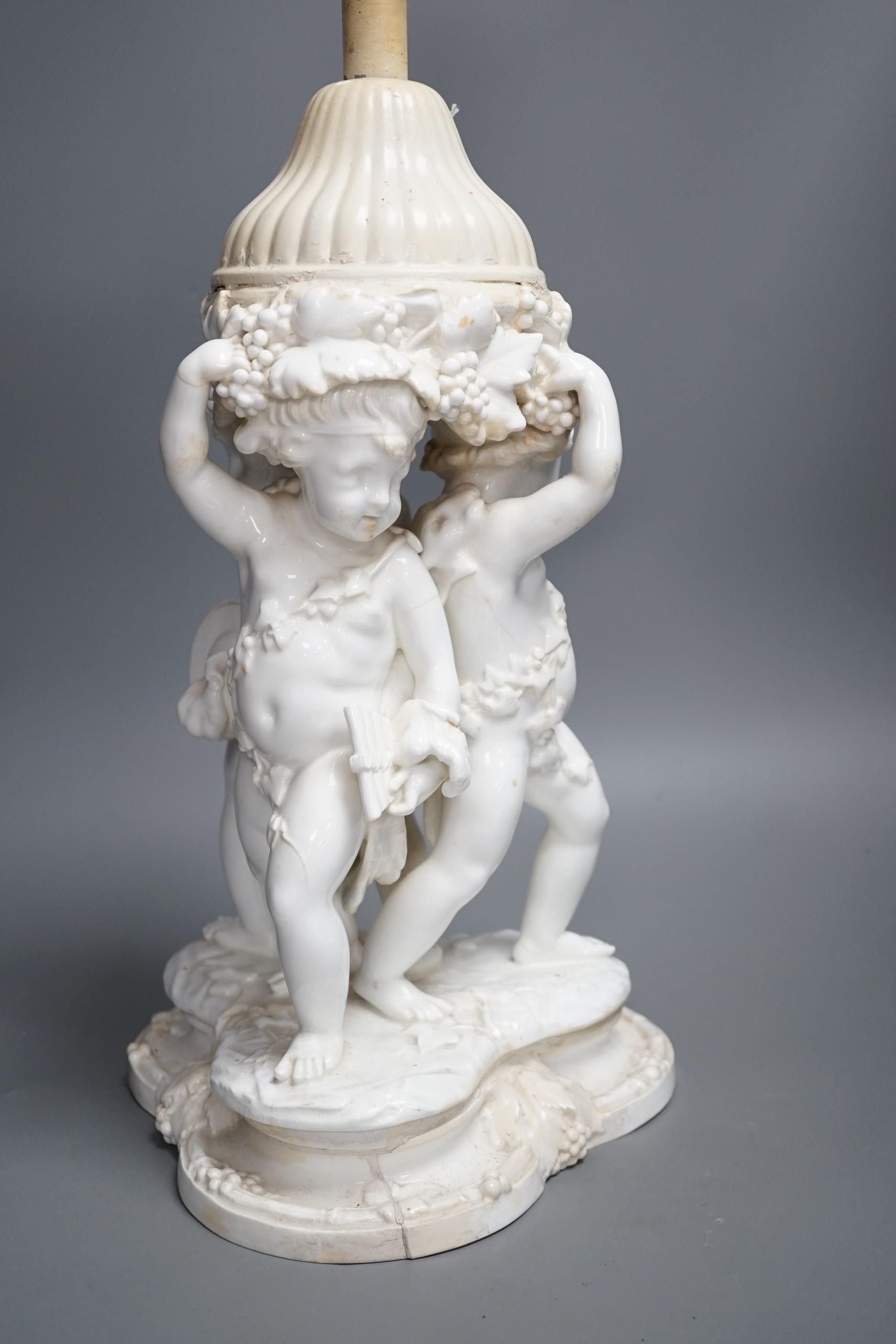 A Victorian English porcelain cherub centrepiece, now mounted as a lamp (restored), possibly Moore Bros., 71 cm height to top of lamp fitting